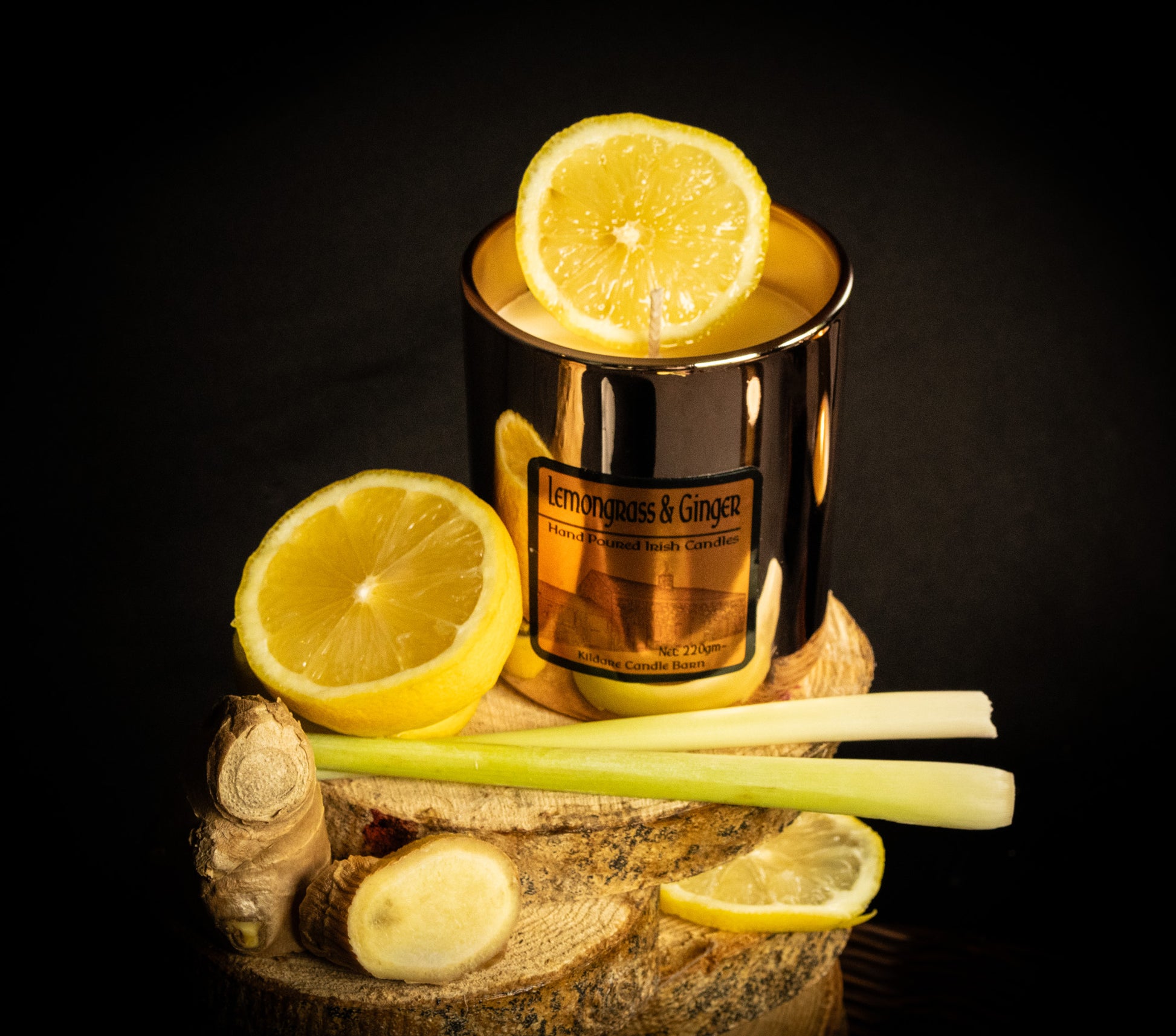 Irish Soy Wax Candle in a copper jar with lemon slices and ginger on a dark background